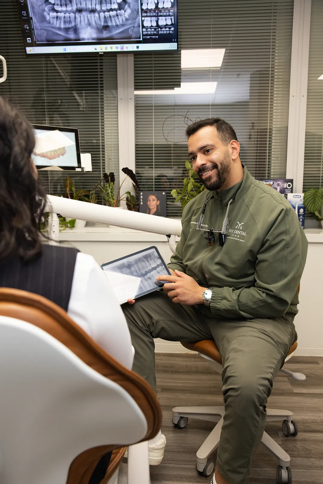 Dentist showing a digital radiograph on a tablet to a patient in a consultation room — My Dental Hub in Skokie, IL