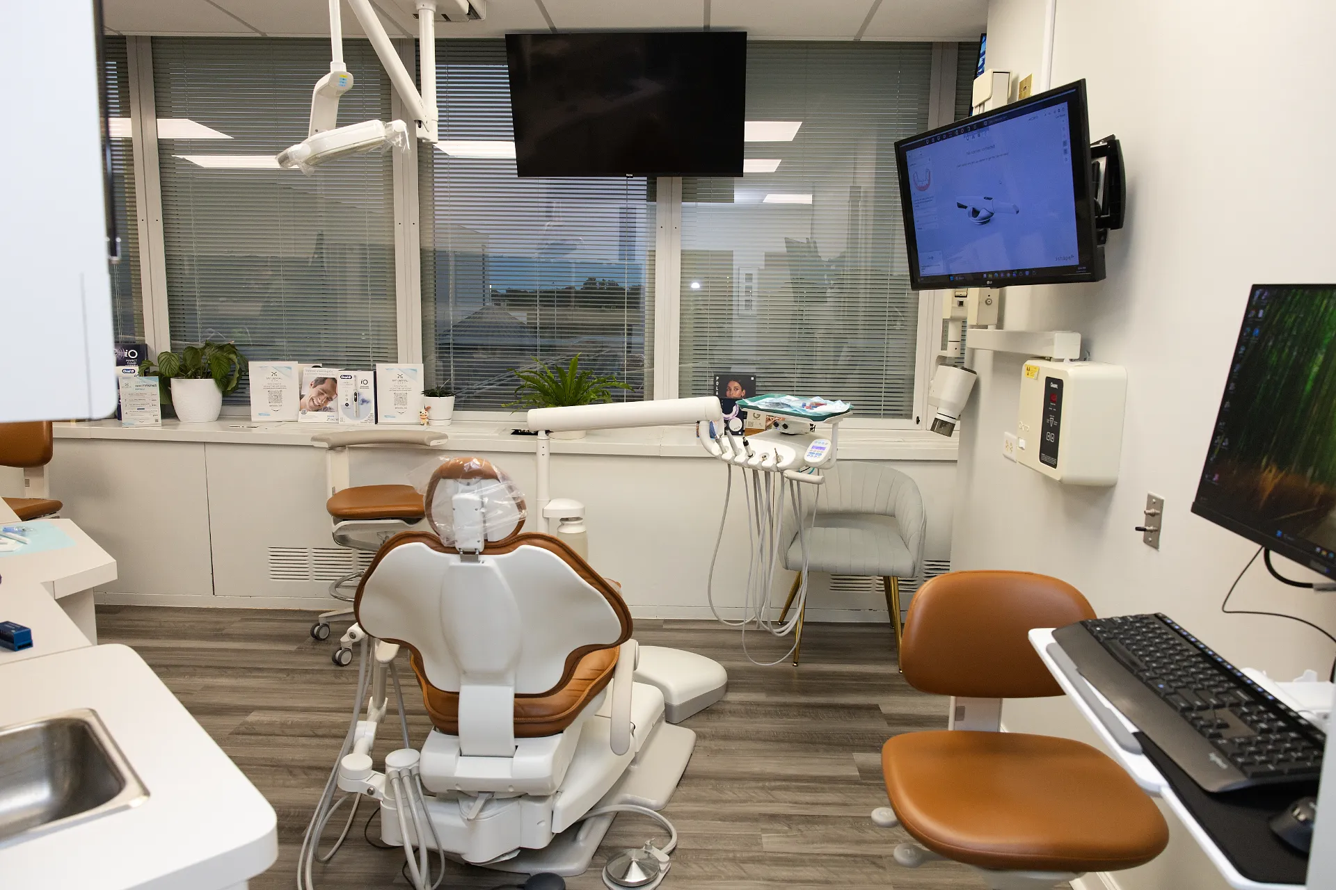 Dental operatory room with a treatment chair, overhead light, and computer monitors — My Dental Hub in Skokie, IL