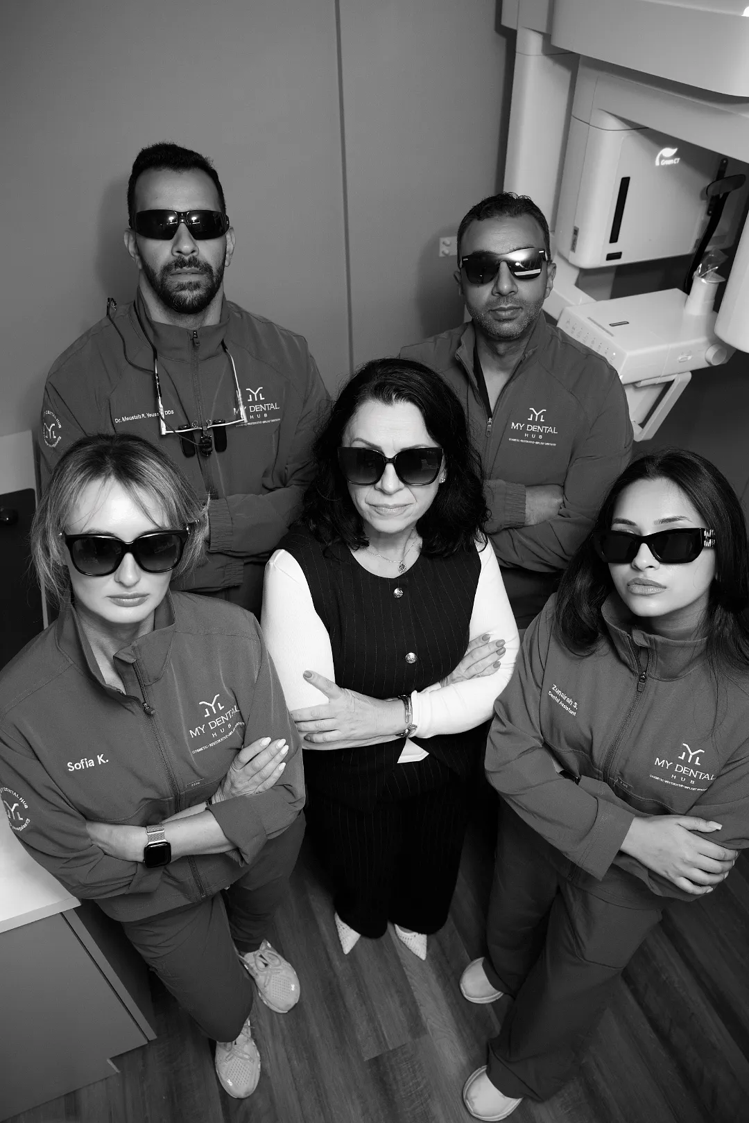 Five dental staff members wearing sunglasses and matching jackets pose together — Skokie, IL